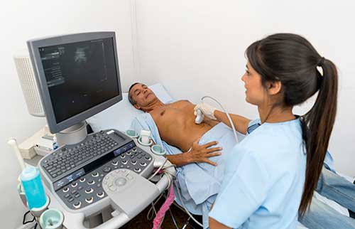 Photograph of a patient during an abdominal sonogram procedure.