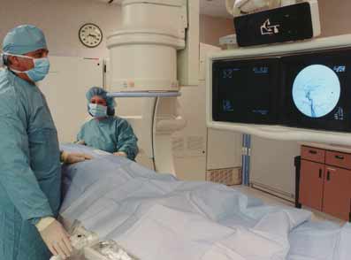 Radiologist with patient undergoing angiogram