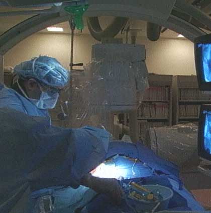 A photo showing a neurointerventional radiology procedure being performed