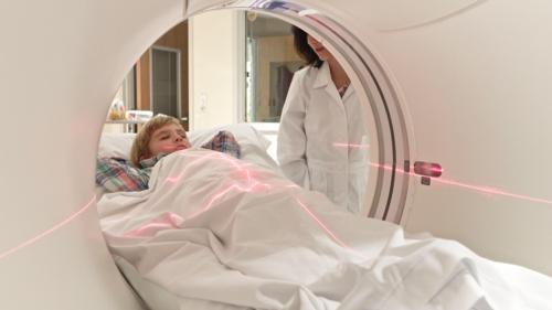 Photograph of a child being prepared for a CT scan.