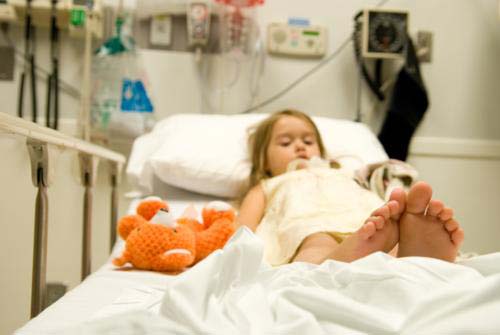 Little girl in hospital bed.