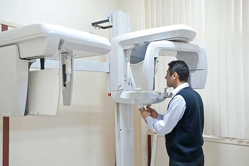 Photo of a patient during a panoramic x-ray exam.