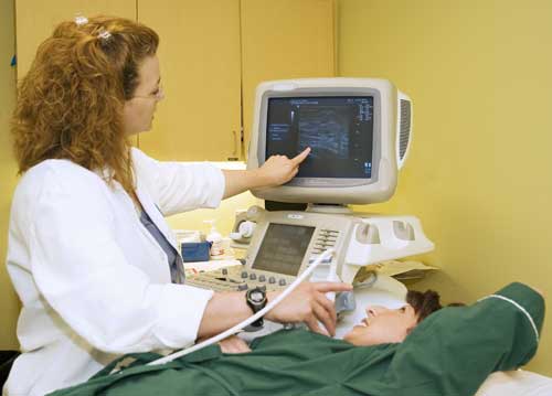 Technologist and patient during breast ultrasound