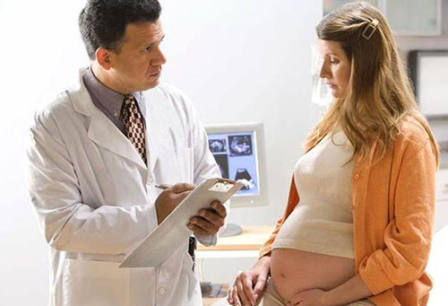A radiologist discussing the results of a CT exam with a patient.