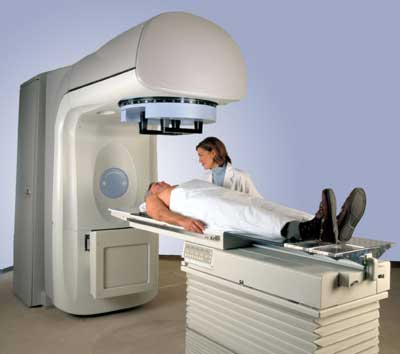 Technologist with patient undergoing radiation therapy with linear accelerator LINAC