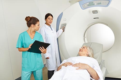 Radiologist preparing a patient for a computed tomography (CT) exam.