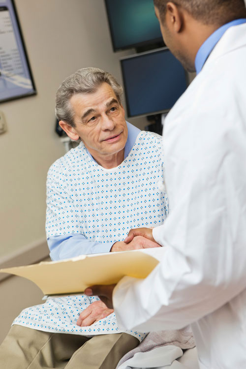 Senior patient with doctor in ER room