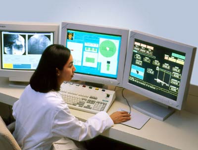 Technologist with linear accelerator LINAC control console