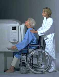 Technologist with patient undergoing chest x-ray