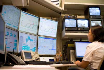 Photograph of a technologist in the proton therapy facility control room