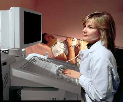 Technologist with patient undergoing ultrasound