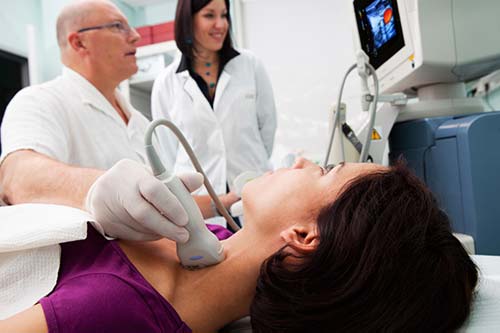 Photograph of a radiologist performing an ultrasound exam.